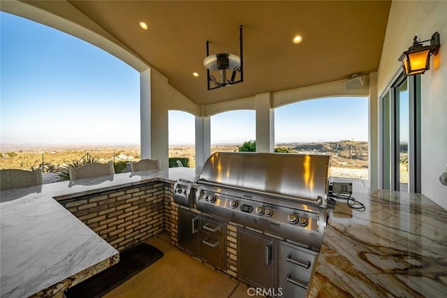 view of patio featuring an outdoor kitchen and a grill