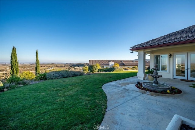 view of yard featuring french doors and a patio area