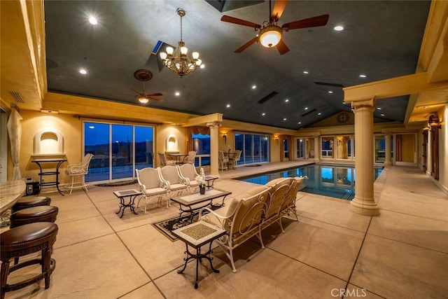 view of pool with a pool, ceiling fan, and ornate columns