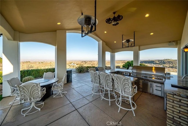 view of patio / terrace featuring outdoor dining space, a sink, grilling area, and an outdoor kitchen