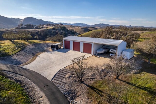exterior space with a detached garage and a mountain view