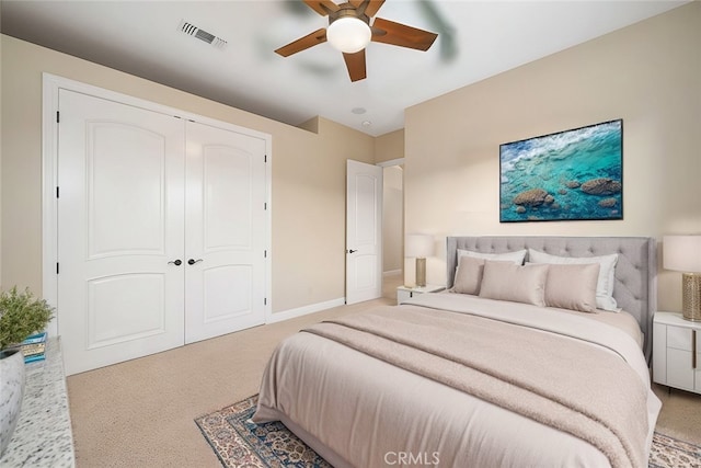 carpeted bedroom with baseboards, visible vents, ceiling fan, and a closet