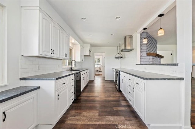 kitchen featuring stainless steel electric stove, dishwasher, white cabinetry, sink, and wall chimney exhaust hood