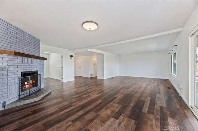 unfurnished living room with dark hardwood / wood-style flooring and a fireplace