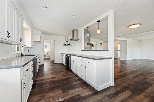 kitchen featuring dark wood-type flooring, sink, white cabinets, stainless steel appliances, and wall chimney range hood