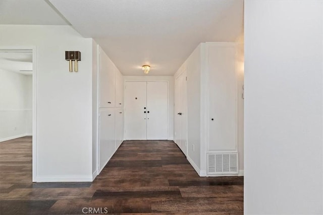 hallway with dark wood-type flooring