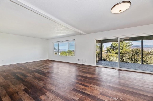 spare room featuring dark hardwood / wood-style floors