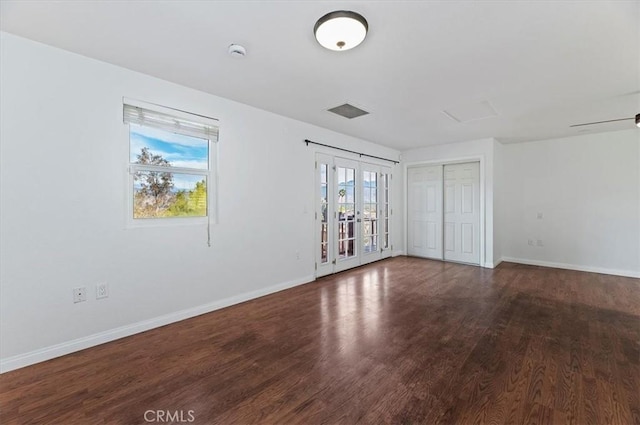 spare room featuring french doors and hardwood / wood-style floors