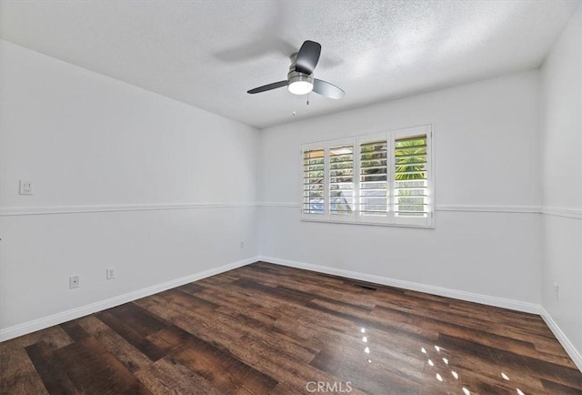 unfurnished room with a textured ceiling, dark wood-type flooring, and ceiling fan