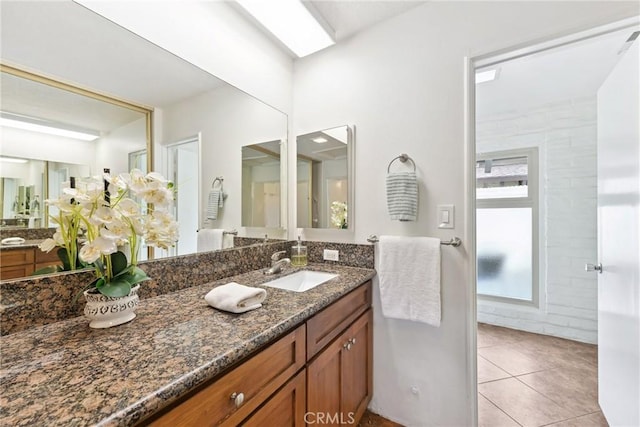 bathroom with vanity, tile patterned flooring, and a skylight