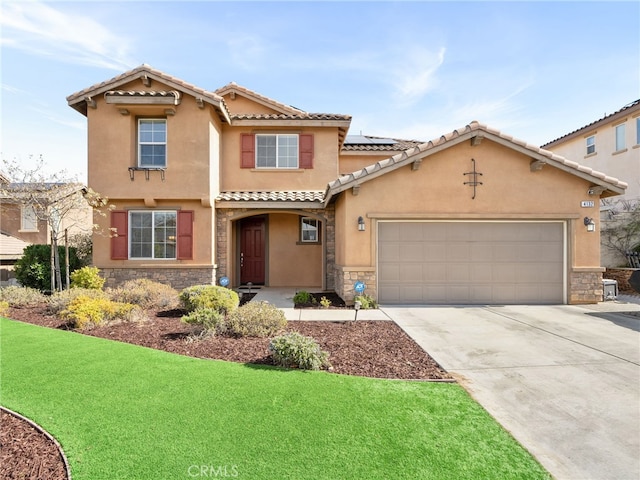 mediterranean / spanish-style home with a garage and a front yard