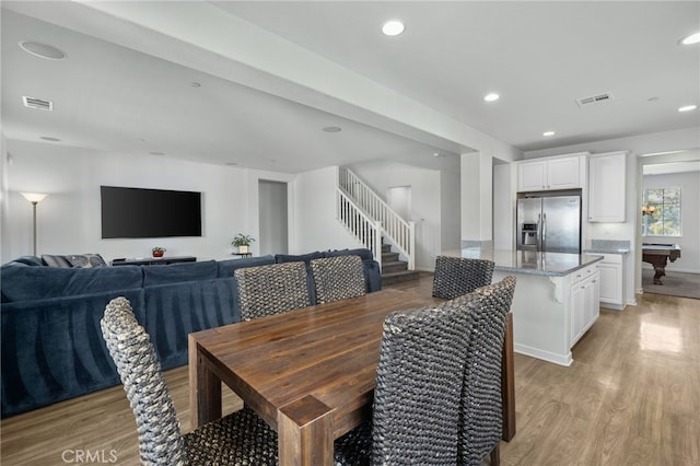 dining space with light hardwood / wood-style floors