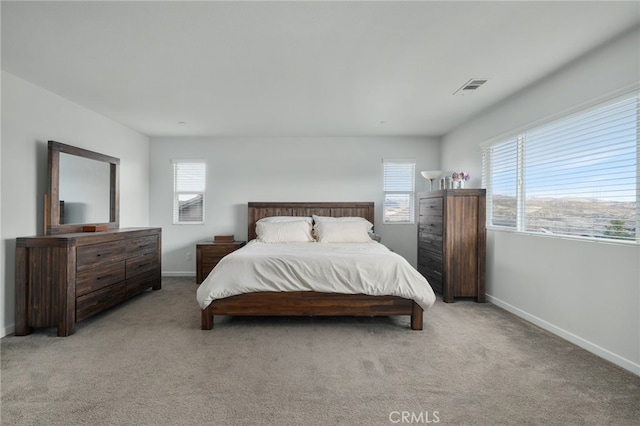 bedroom featuring light colored carpet