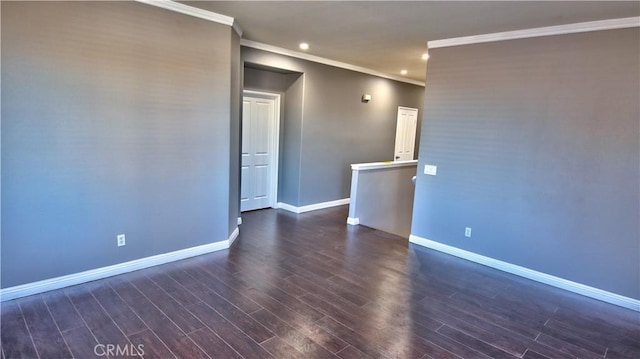 empty room featuring dark hardwood / wood-style flooring and crown molding