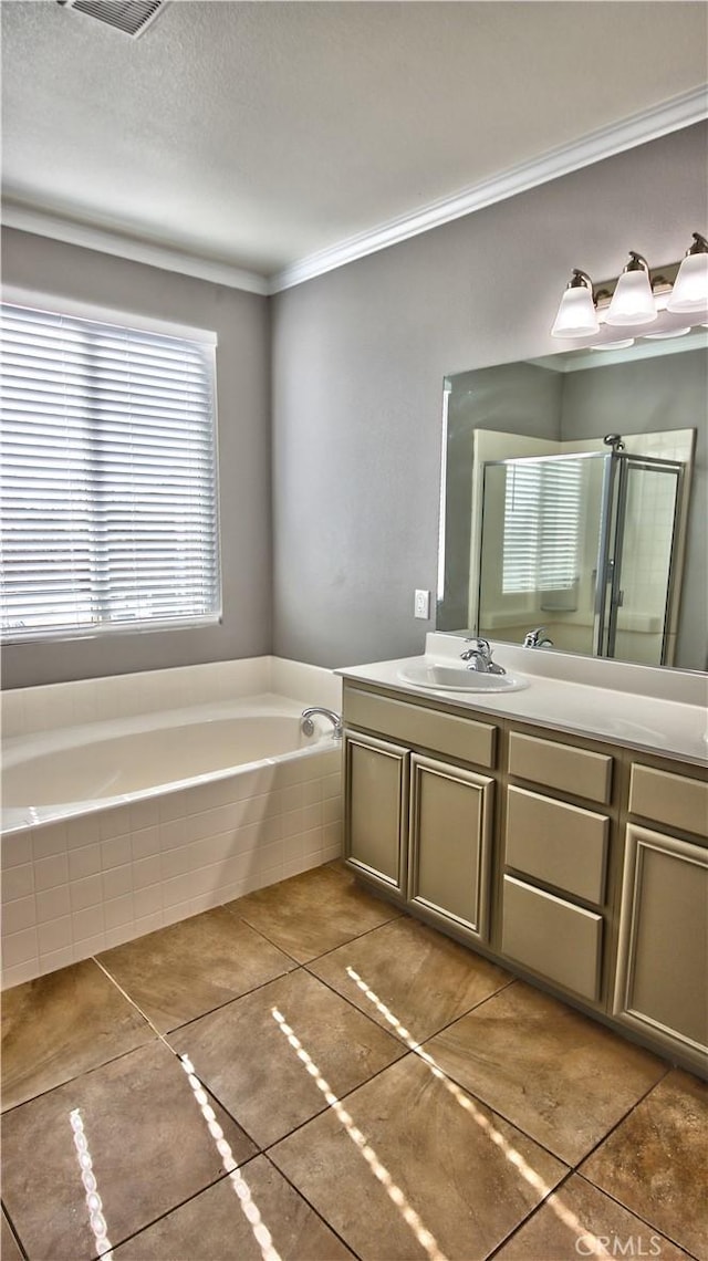 bathroom with crown molding, tile patterned flooring, vanity, a textured ceiling, and independent shower and bath