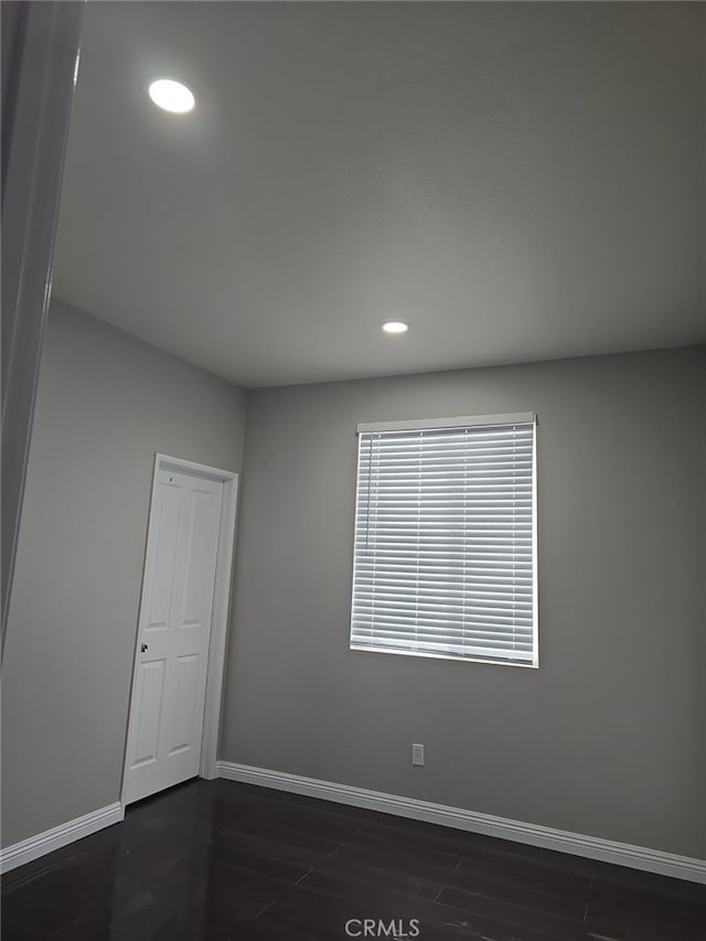 empty room featuring dark hardwood / wood-style flooring