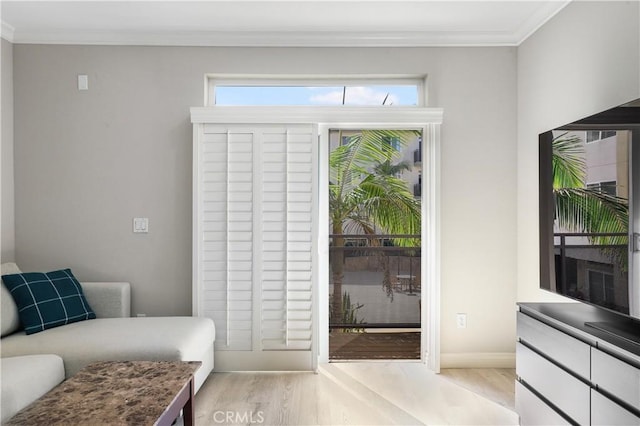 doorway to outside featuring crown molding, light hardwood / wood-style floors, and a wealth of natural light