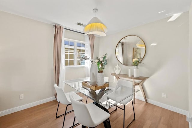 dining space with light hardwood / wood-style flooring