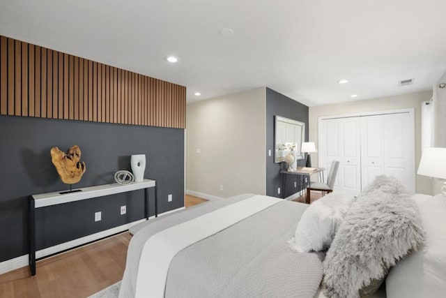 bedroom with hardwood / wood-style flooring and a closet