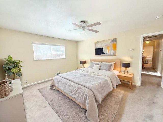 bedroom with ceiling fan and light carpet