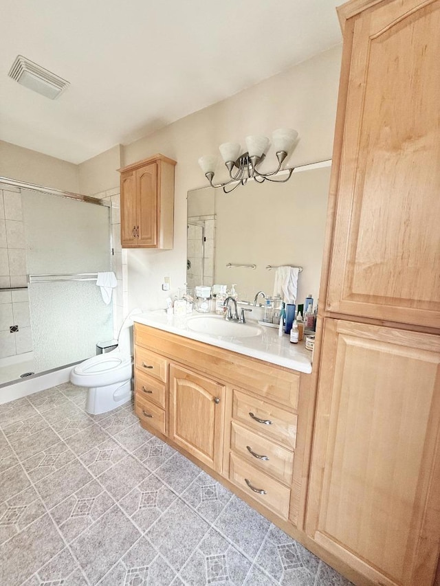 bathroom featuring vanity, toilet, and a shower with door