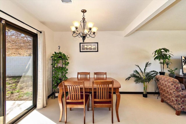 dining space with a chandelier and beam ceiling