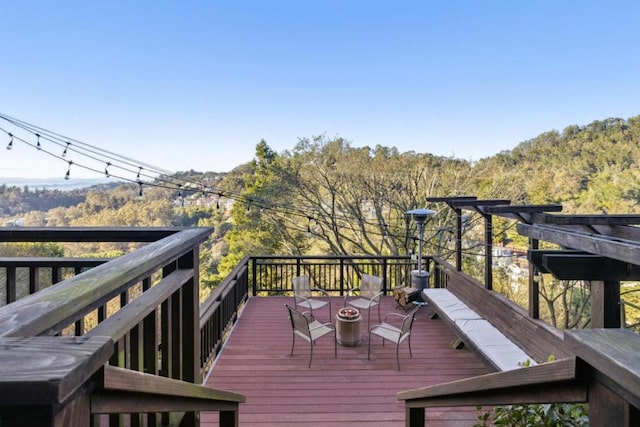 wooden deck featuring an outdoor fire pit