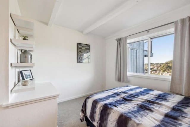 carpeted bedroom with beamed ceiling