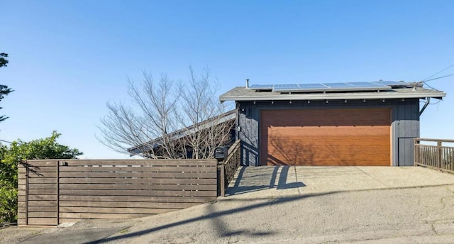 view of front of home with a garage and solar panels