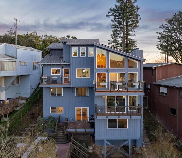 view of back house at dusk