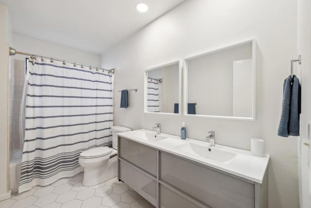 full bathroom featuring vanity, tile patterned floors, toilet, and shower / bathtub combination with curtain