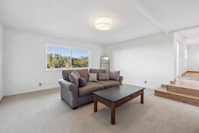 living room with light colored carpet and beam ceiling