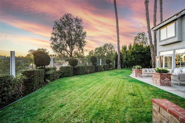 yard at dusk with a patio and an outdoor hangout area