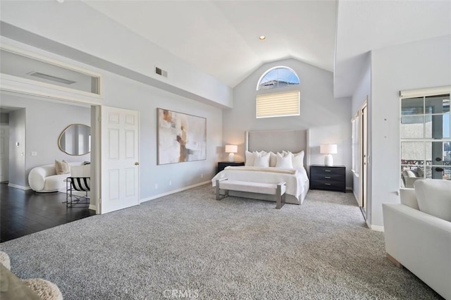 bedroom featuring high vaulted ceiling and dark colored carpet