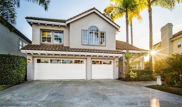 mediterranean / spanish-style house with a garage