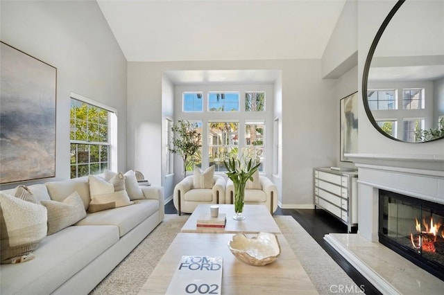 sunroom featuring lofted ceiling and a premium fireplace