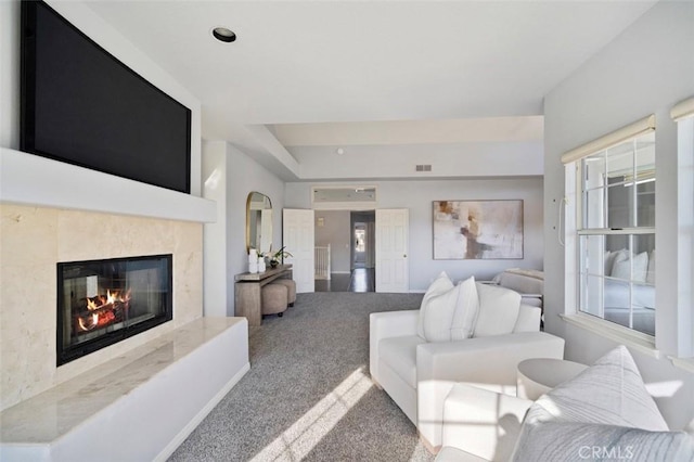 living room featuring carpet, plenty of natural light, and a fireplace