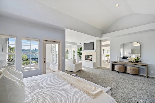 carpeted bedroom with vaulted ceiling and a multi sided fireplace