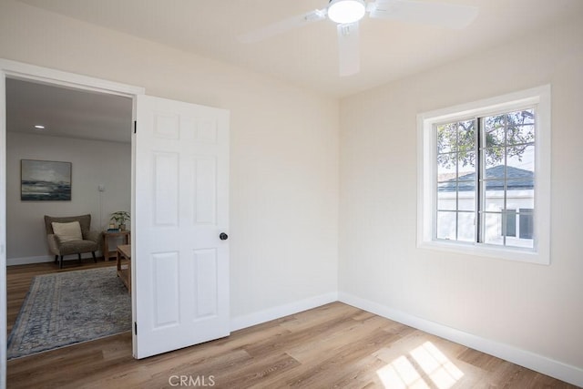 spare room with light hardwood / wood-style floors and ceiling fan