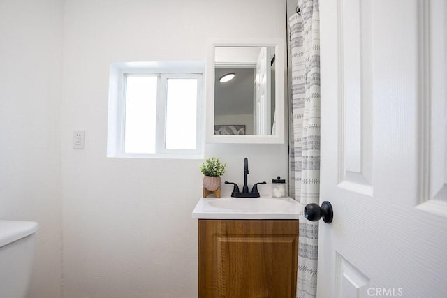 bathroom featuring vanity and toilet