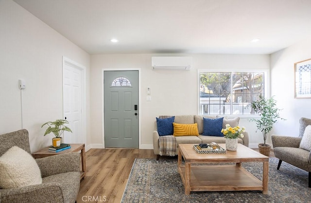 living room with hardwood / wood-style floors and a wall unit AC