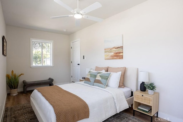 bedroom with dark wood-type flooring and ceiling fan