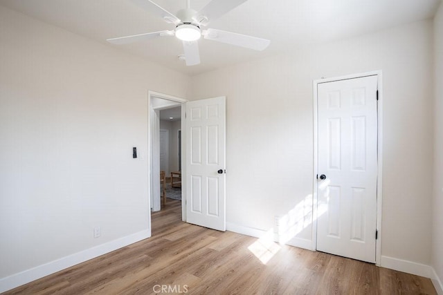 unfurnished bedroom featuring ceiling fan and light hardwood / wood-style floors