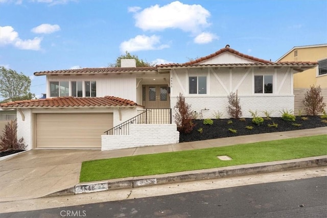 mediterranean / spanish-style home with a garage