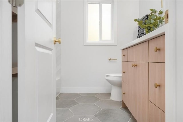 bathroom featuring tile patterned flooring, vanity, and toilet