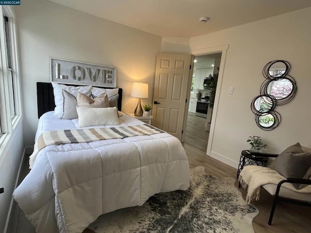 bedroom featuring hardwood / wood-style floors and multiple windows