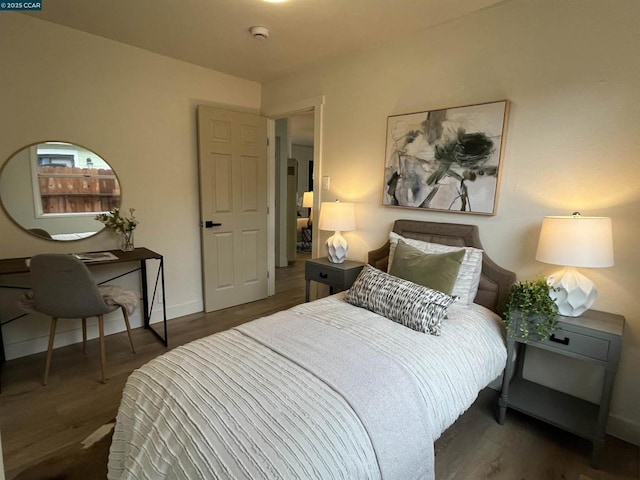 bedroom with dark hardwood / wood-style floors