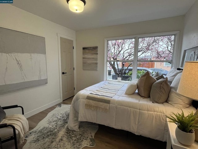 bedroom with dark hardwood / wood-style flooring