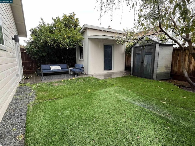 view of yard with outdoor lounge area and a shed