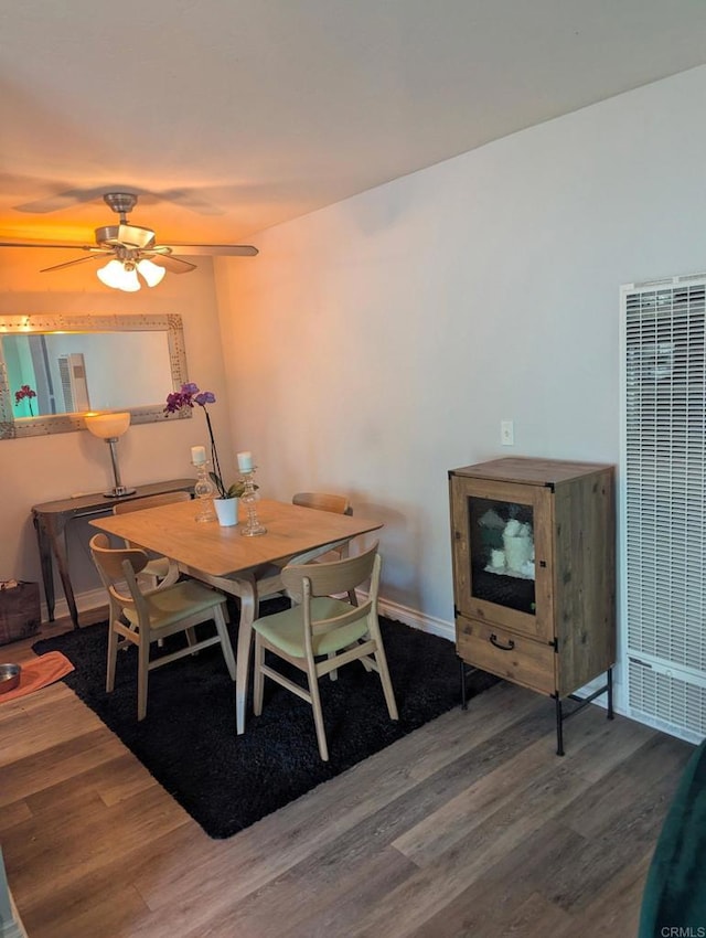 dining area featuring ceiling fan and wood-type flooring